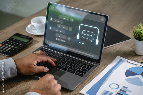 Businessman using AI chatbot interface on laptop for digital contact center support chatbot technology assisting