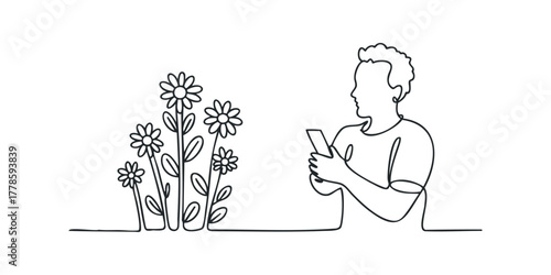 Man taking picture of flowers with smartphone
