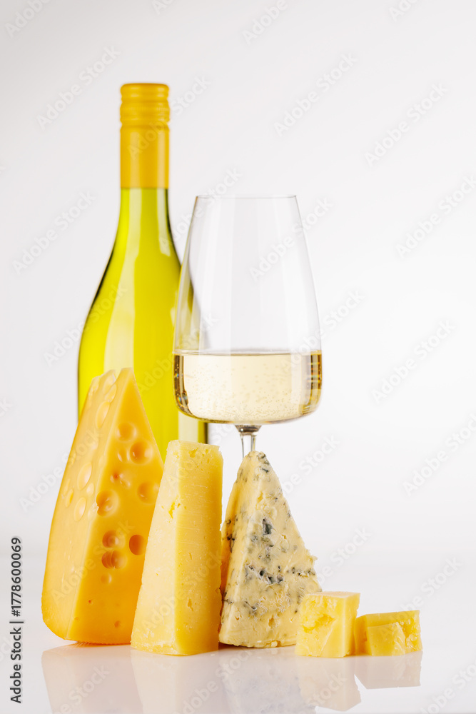 Fototapeta premium Assorted cheeses and wine on white background