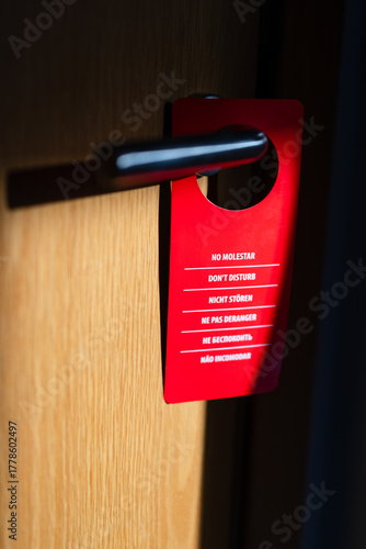 Red do not disturb sign on a modern door handle