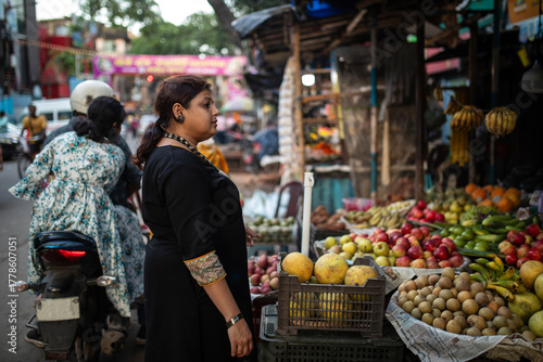 Indian woman purchasing fruit in local shop