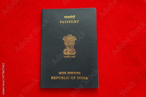 Old Indian nationality or citizenship official identification document ordinary passport with embossed gold text isolated on table background. International tour and travel identity concept.