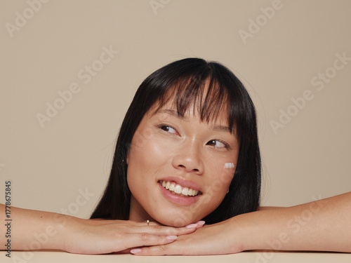 Smiling Girl With Flawless Skin Enjoying a Moment of Joy Indoors