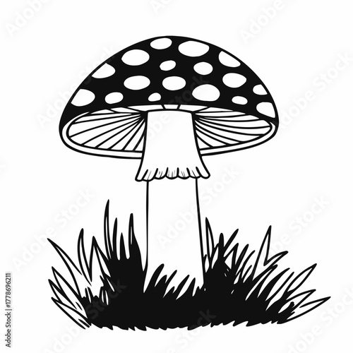 A classic black and white silhouette of a spotted mushroom standing in grass isolated on white background