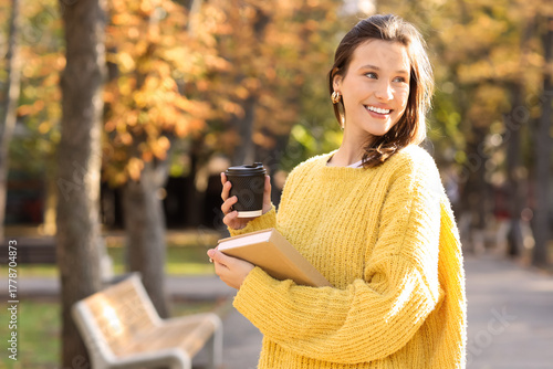 Happy young woman with book...