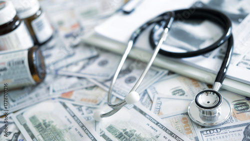 Prescription medicine bottles with stethoscope and US dollars reflecting drug cost burden, insurance pricing problems and expensive patient treatment.