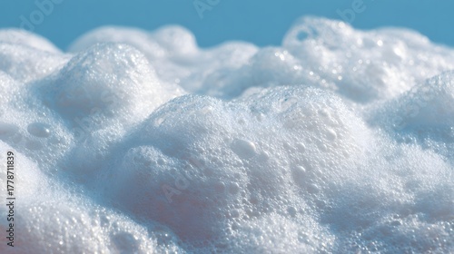 Fototapeta Naklejka Na Ścianę i Meble -  Close up view of sea foam bubbles against a light blue background
