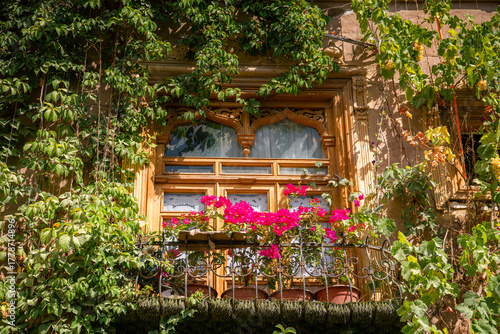 Fototapeta Naklejka Na Ścianę i Meble -  The small balconies and carved walls of the old house in Kashgar Old Town, Xinjing, China, blue sky with copy space for text