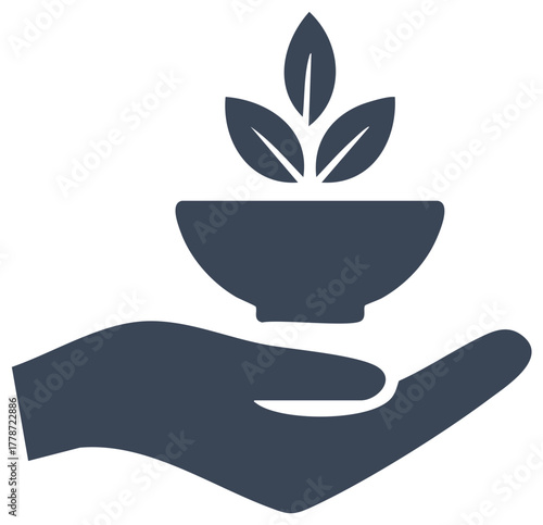 Hand holding a bowl with growing plant representing healthy eating and organic food