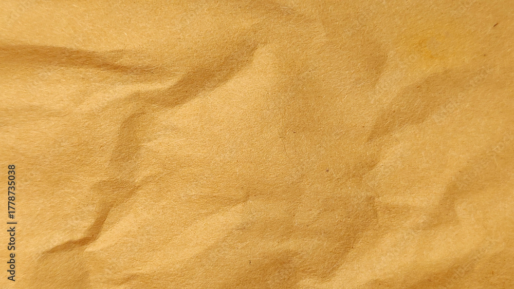 Naklejka premium Crumpled Old Brown Kraft Paper Macro Texture Full Frame Background with Vintage Character