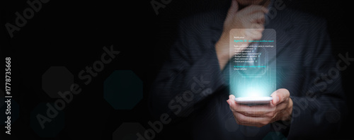 Businessman using smartphone with glowing digital display showing agentic AI notification and workflow automation, symbolizing intelligent decision systems and autonomous technology that can decide.
