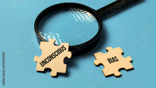 Canvas Print Examining Unconscious Bias: Magnifying Glass Focuses on Two Puzzle Pieces on a B