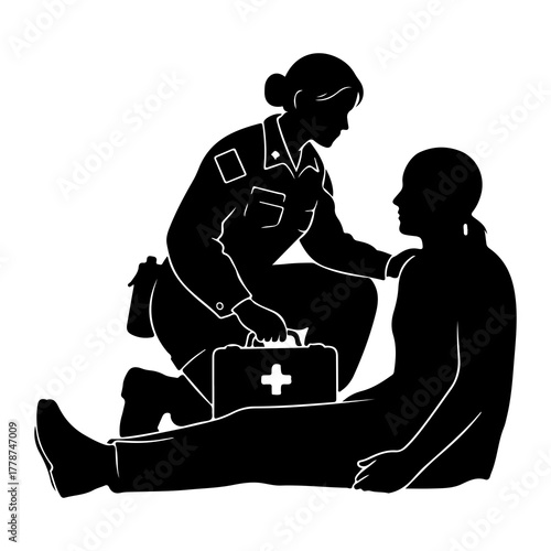 Medic tending injured person with first aid kit medical