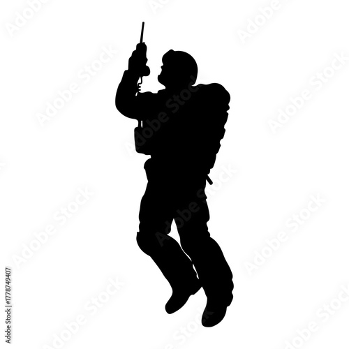 Silhouette of person rappelling with equipment backpack