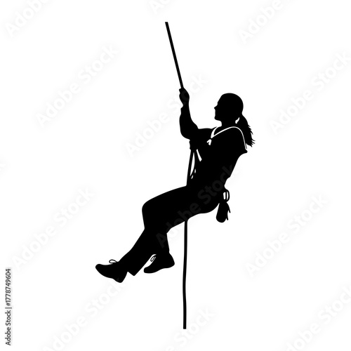 Silhouette person rappelling down rope climbing
