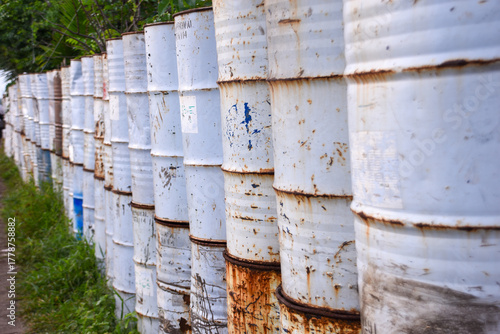 Unused barrels neatly arranged to form a yard boundary wall. Reusing used items into something more useful.