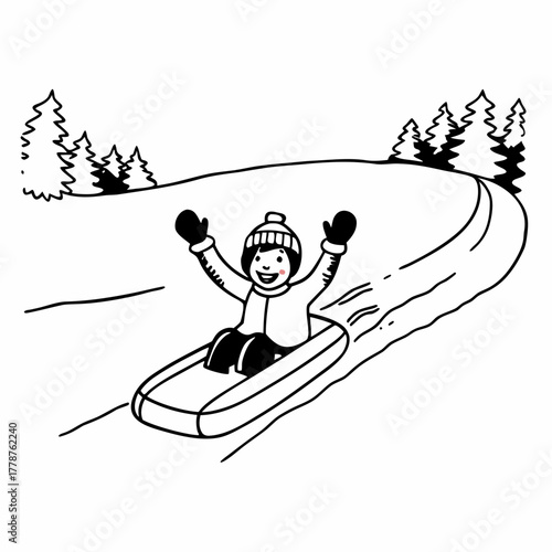 Child sledding down a snowy hill