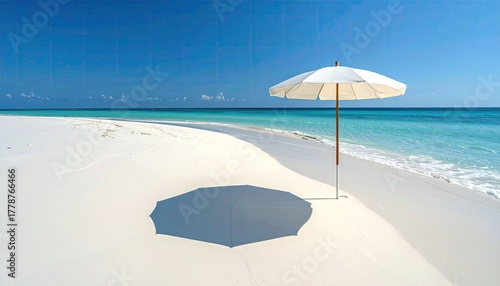 Fototapeta Naklejka Na Ścianę i Meble -  White beach umbrella casts a shadow on white sand beach with turquoise water and clear blue sky in the Maldives