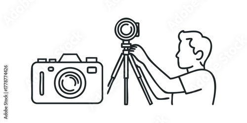 Man adjusting tripod for camera