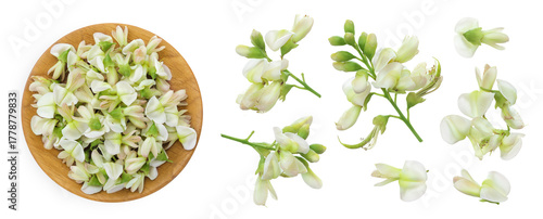 flowers of Sophora japonica or Styphnolobium japonicum in wooden bowl isolated on white background. Top view. Flat lay