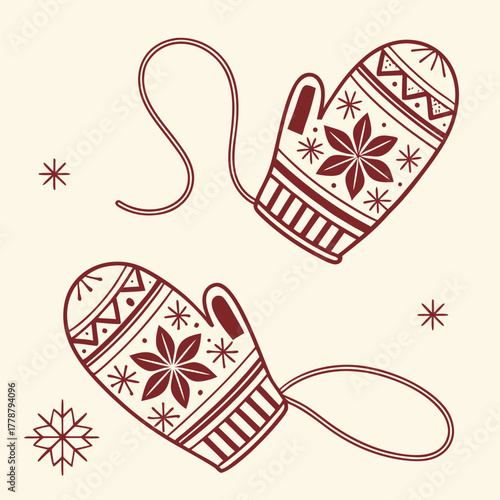 A pair of winter mittens with snowflake pattern