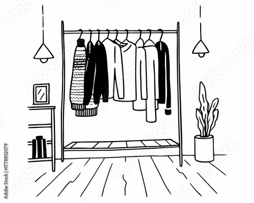 Clothes rack with sweaters and lamps