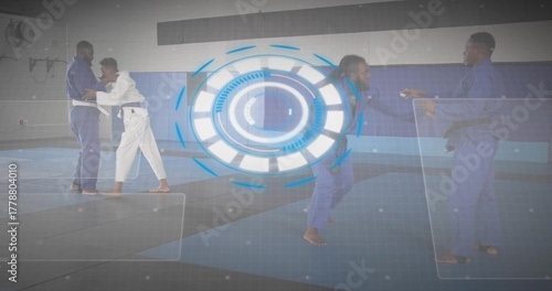 Practicing grappling martial arts fighters wearing gis on mats in dojo, with digital overlays