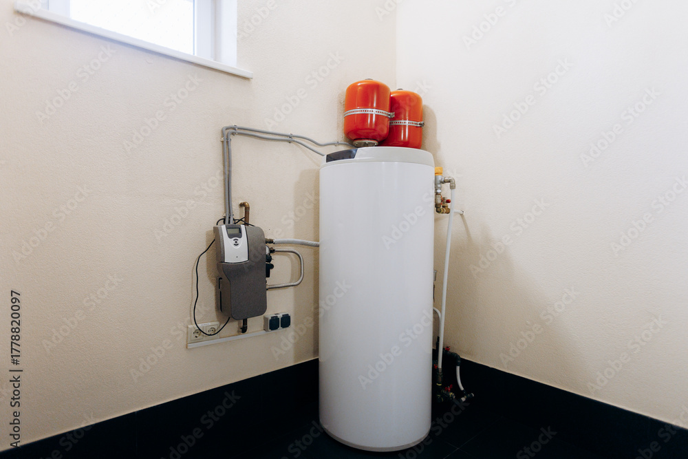 Obraz premium thermal tank installation, energyefficient utility tank situated beneath window with accessible