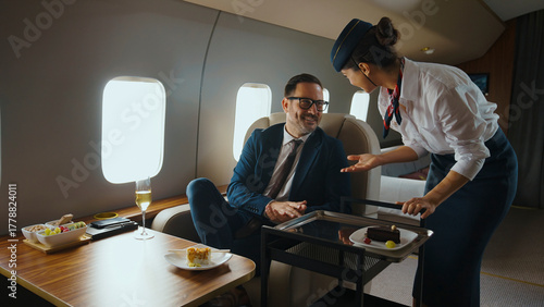 Konstfotografi Flight attendant providing excellent service, offering a sweet dessert from a se