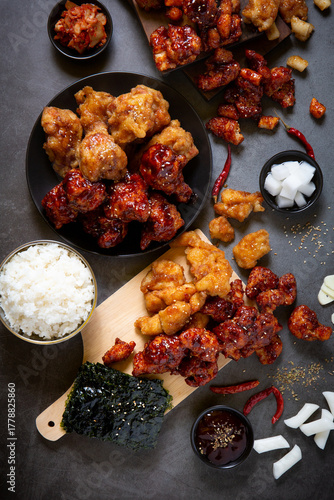 Crispy Korean Fried Chicken with Spicy Chili Sauce and Garlic Sauce on Black background.