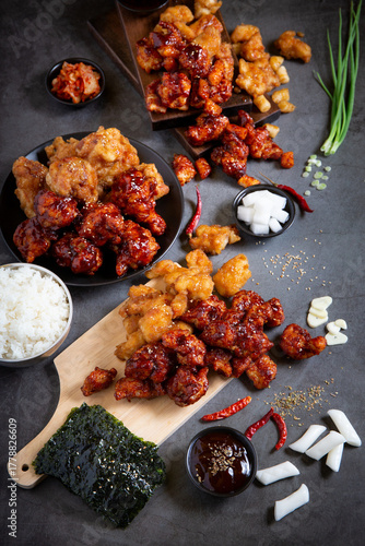 Crispy Korean Fried Chicken with Spicy Chili Sauce and Garlic Sauce on Black background.