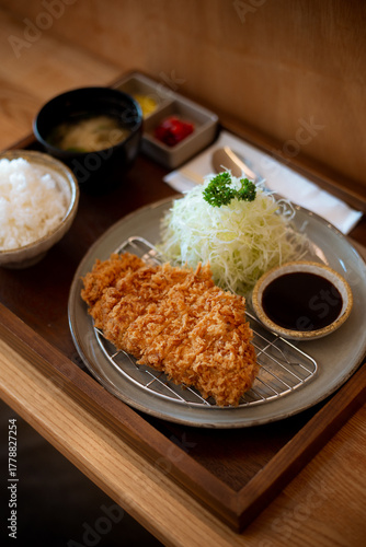 Japanese deep fried pork or Tonkatsu set with rice and miso soup on table.