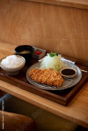 Japanese deep fried pork or Tonkatsu set with rice and miso soup on table.