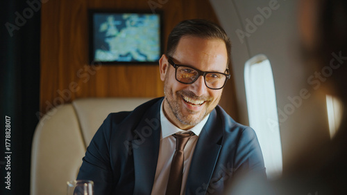 Schilderij op canvas Businessman looking at the camera, smiling genuinely while traveling on a privat