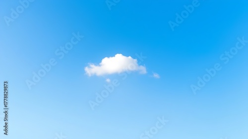 A solitary white cloud drifting across a clear blue sky, embodying simplicity and peace.
