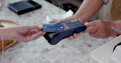 Close up of credit card being inserted into point of sale machine by customer during payment at small cafe representing cashless transaction and modern service in retirement business