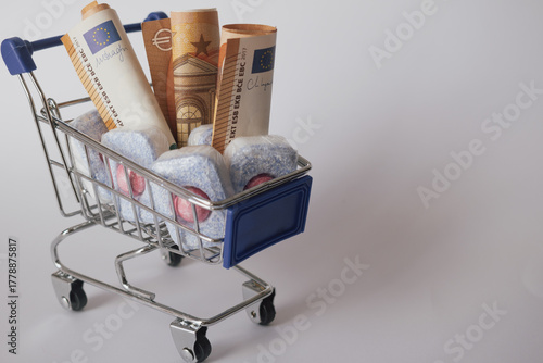 Cost of living: expensive dishwasher tablets next to euro currency, showing household expense