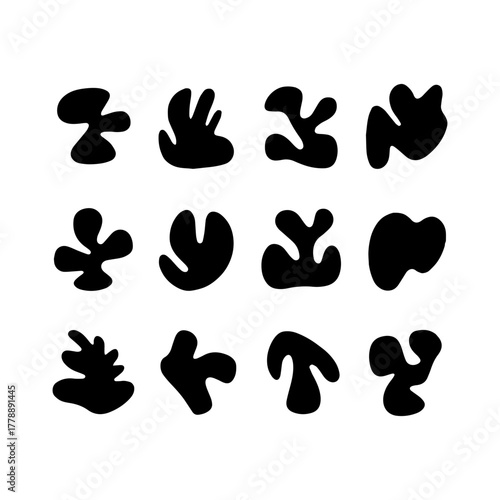 Abstract black shapes arranged in a grid pattern, showcasing creative design and artistic expression in a minimalistic style