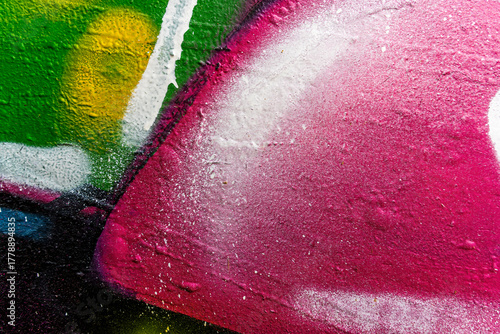 Beautiful brick wall colorful street art graffiti background. Abstract creative spray drawing fashion colors painting on the walls of the city. Urban Culture, aerosol texture