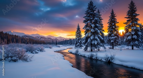 Winter landscape with a snowy river, evergreen trees, mountains, and a colorful sunset sky.