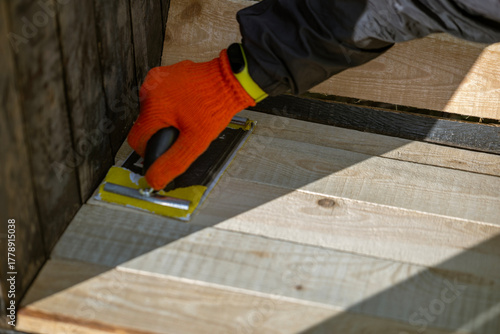 Wallpaper Mural A high-angle view of a worker's hand in an orange glove using a Torontodigital.ca