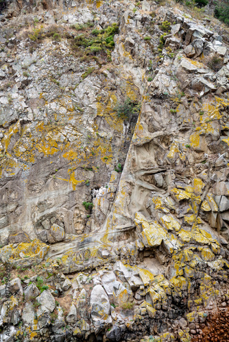 The rock structure of a mountain on a clear sunny day. The design of the backgrounds structure.