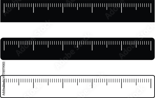 Three isolated rulers in black and white silhouettes showing precise measurement markings for educational or design purposes