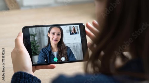 Wallpaper Mural Woman video chatting on smartphone indoors. Torontodigital.ca