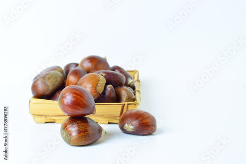 close up, chestnuts in a basket and white background