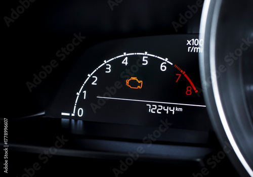 Check engine warning light on car dashboard, close-up of illuminated malfunction indicator symbol, vehicle diagnostics, car maintenance and engine problem alert concept