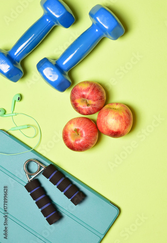 Physical activity and good nutrition lifestyle concept, represented with sports and fruit accessories. Vertical shot.