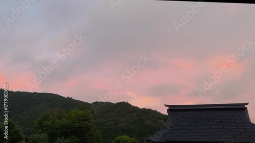 View of a traditional Japanese house roof with mountain