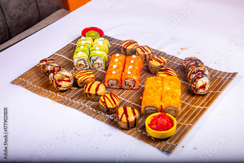 Delicious Japanese sushi set with nigiri, maki rolls, and soy sauce served on a wooden board. Traditional Asian cuisine concept.