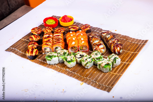 Delicious Japanese sushi set with nigiri, maki rolls, and soy sauce served on a wooden board. Traditional Asian cuisine concept.